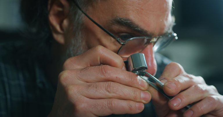 Jeweler looking at a lab created diamond