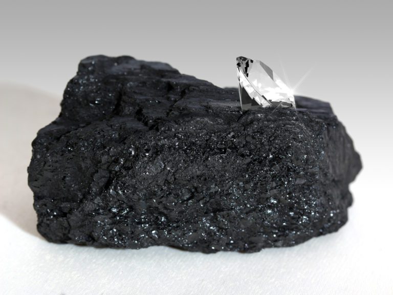 A diamond in a pile of coal shows the evolution of a precious gem